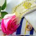 Wedding rings and roses on prayer shawl