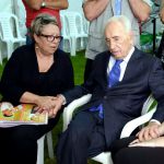 Peres comforts grieving widow