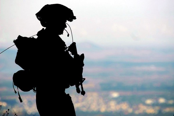 An IDF soldier stands guard at a military base in the Golan Heights.