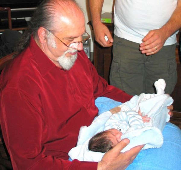 An Israeli grandfather holds his grandchild after the Brit Milah.