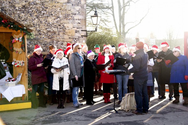 Members of the Winchester Musicals and Opera Society sing carols at Winchester Cathedral in England.