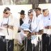 Jewish men wearing tallitot pray at the Western (Wailing) Wall in Jerusalem.