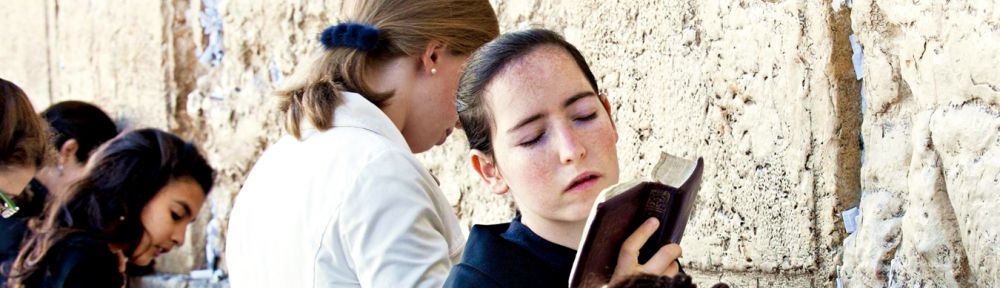 A Jewish woman sways back and forth as she prays at the Western (Wailing) Wall in Jerusalem.