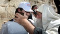 An observant Jewish Israeli blesses a father and son at the Western Wall (Israel Tourism photo by Sasson Tiram)