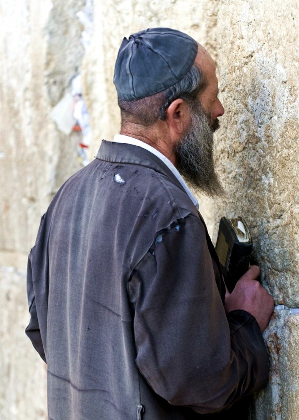 An impoverished Jewish man prays at the Western (Wailing) Wall.