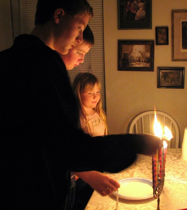 children lighting the hanukkiah