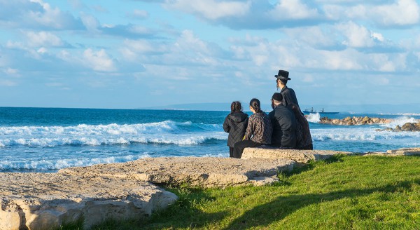 Jewish family overlooking Mediterranean Sea in Israel.