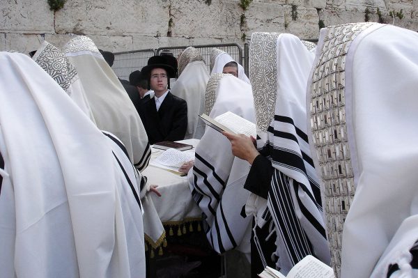 Jewish men wearing their tallit (prayer shawls) pray at the Western (Wailing) Wall in Jerusalem.