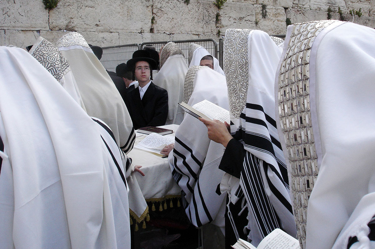 Jewish men wearing their tallit (prayer shawls) pray at the Western (Wailing) Wall in Jerusalem.
