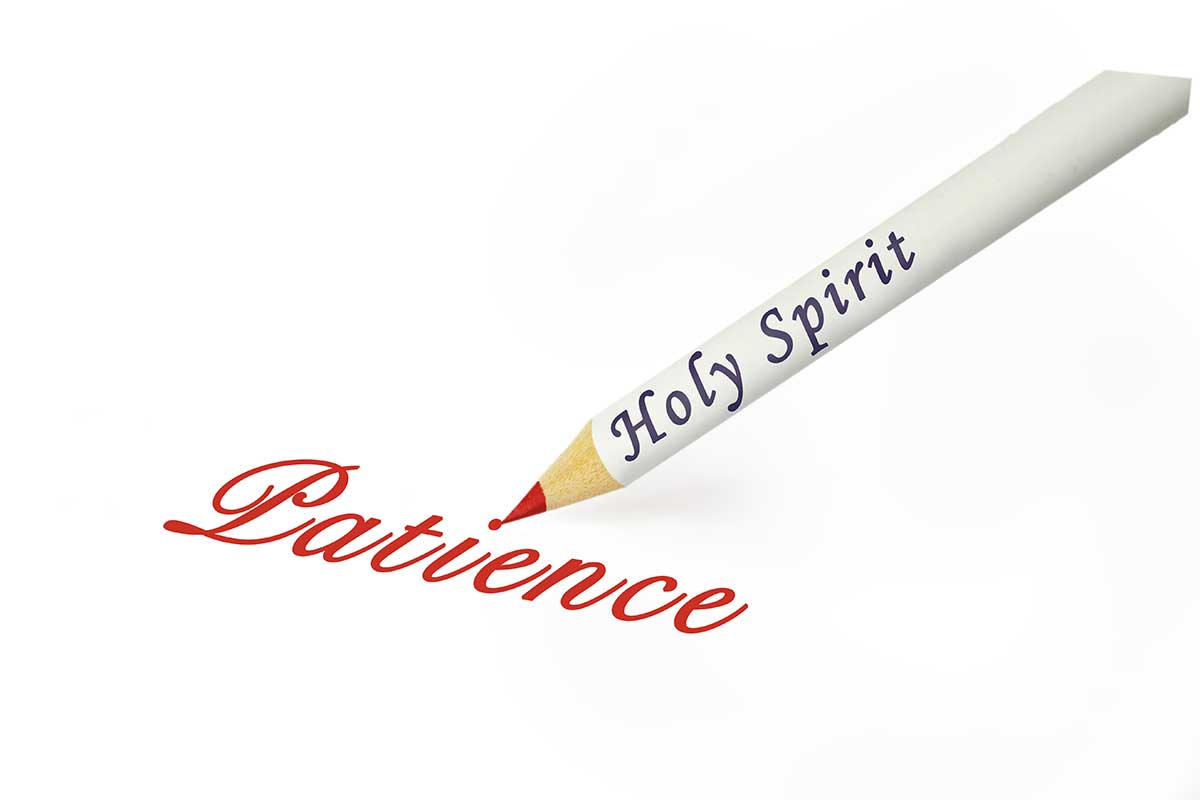 The words "Holy Spirit" is written on a pencil and the pencil has written the word "Patience on a paper.